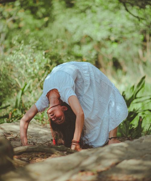 Person meditating peacefully in a serene natural environment.